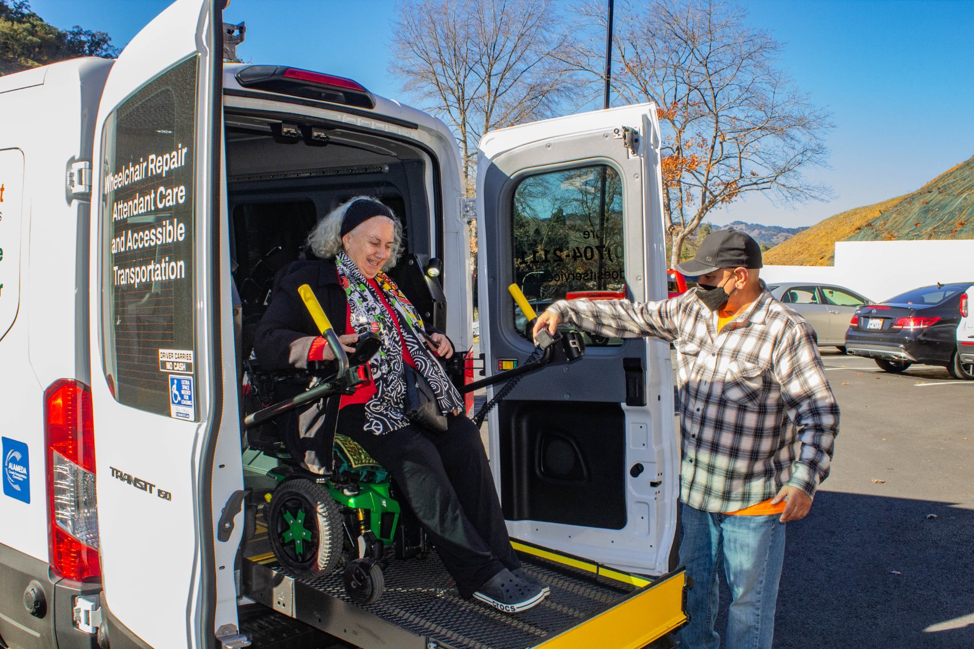 Rodney helps a client disembark from one of our accessible transportation vans.