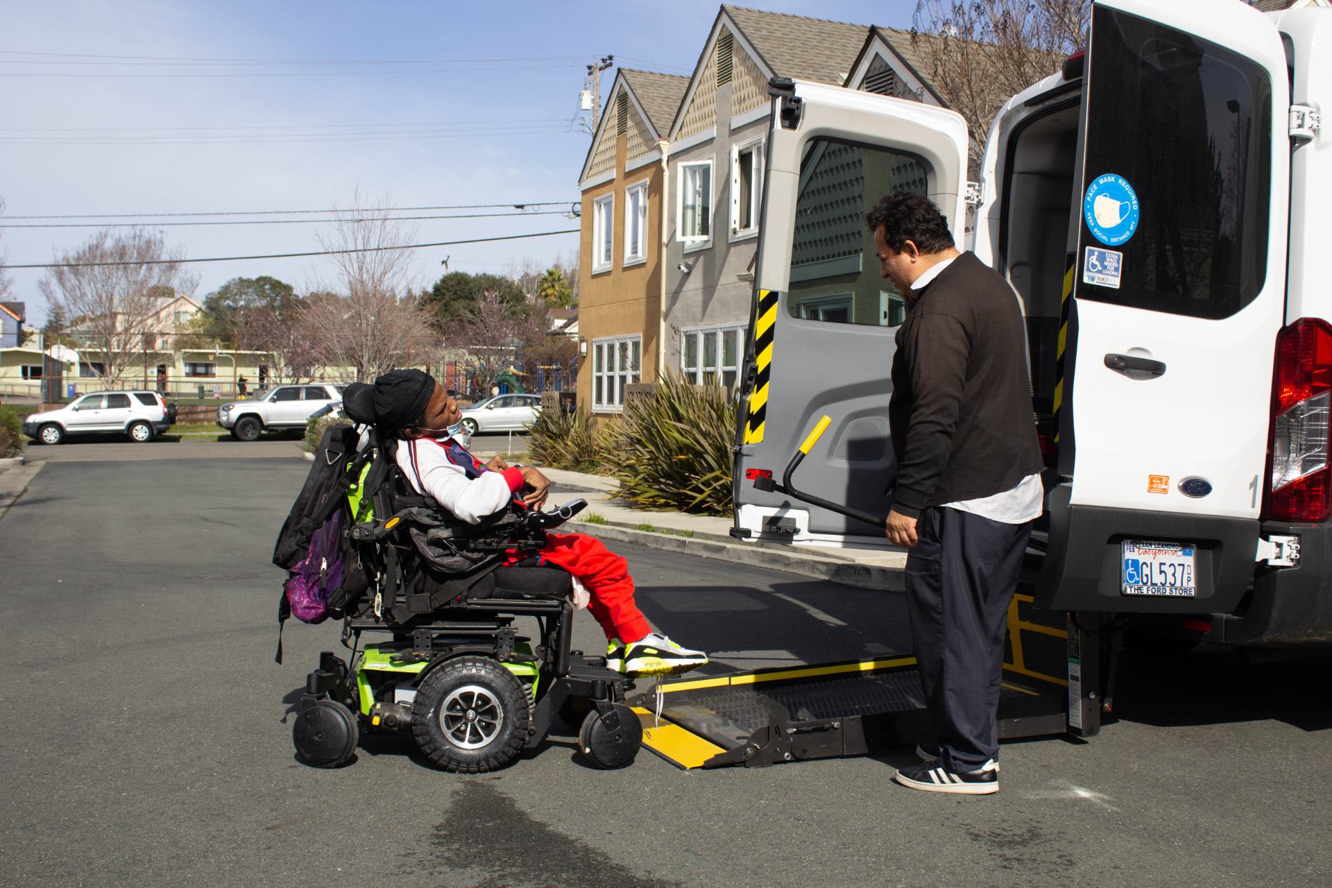 Our Transportation Coordinator, Ed, helps a client board our accesible transportation van.