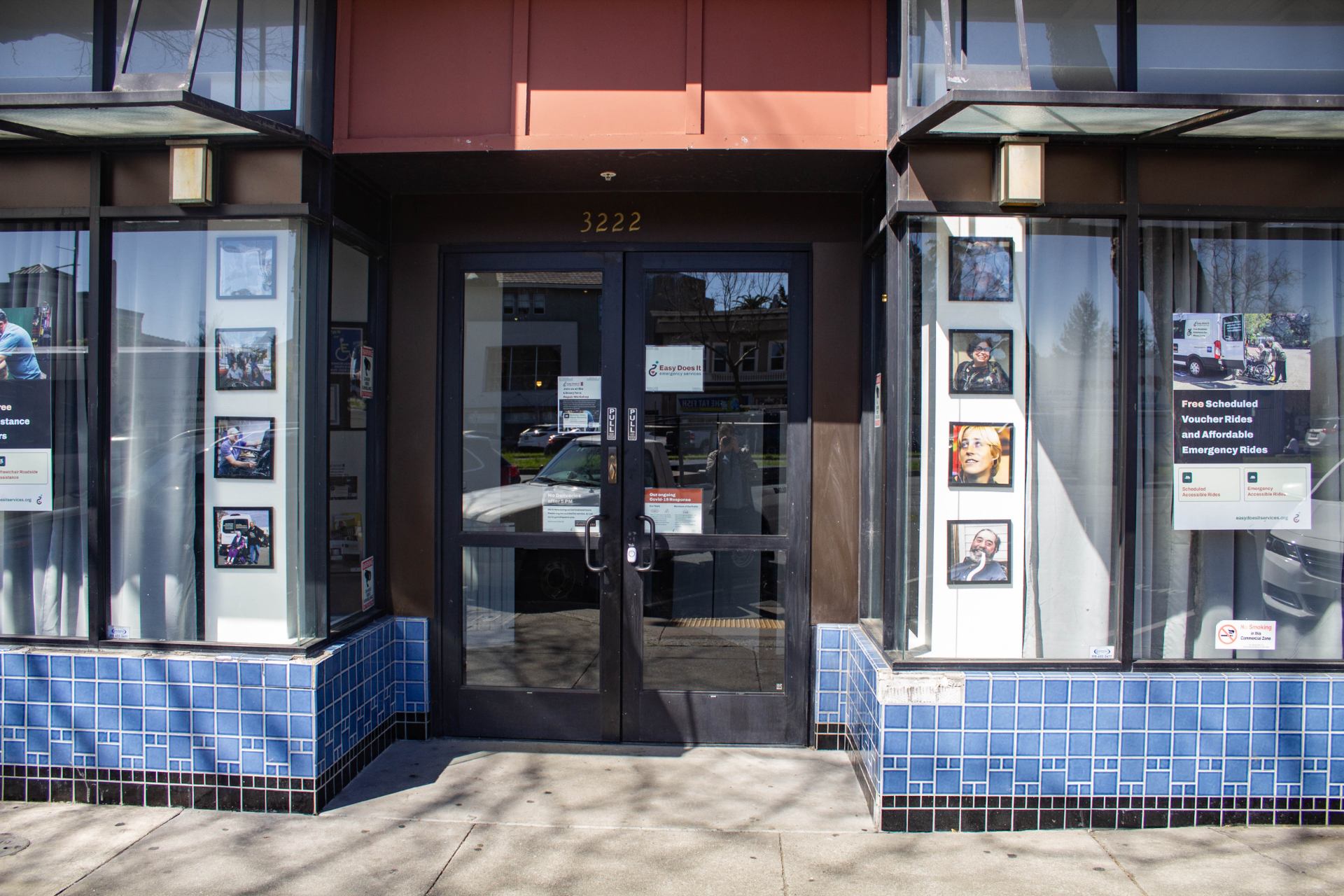 A photo of Easy Does It's storefront. Featuring newly hung photos of Hale, Judy, CeCe, and Ed.