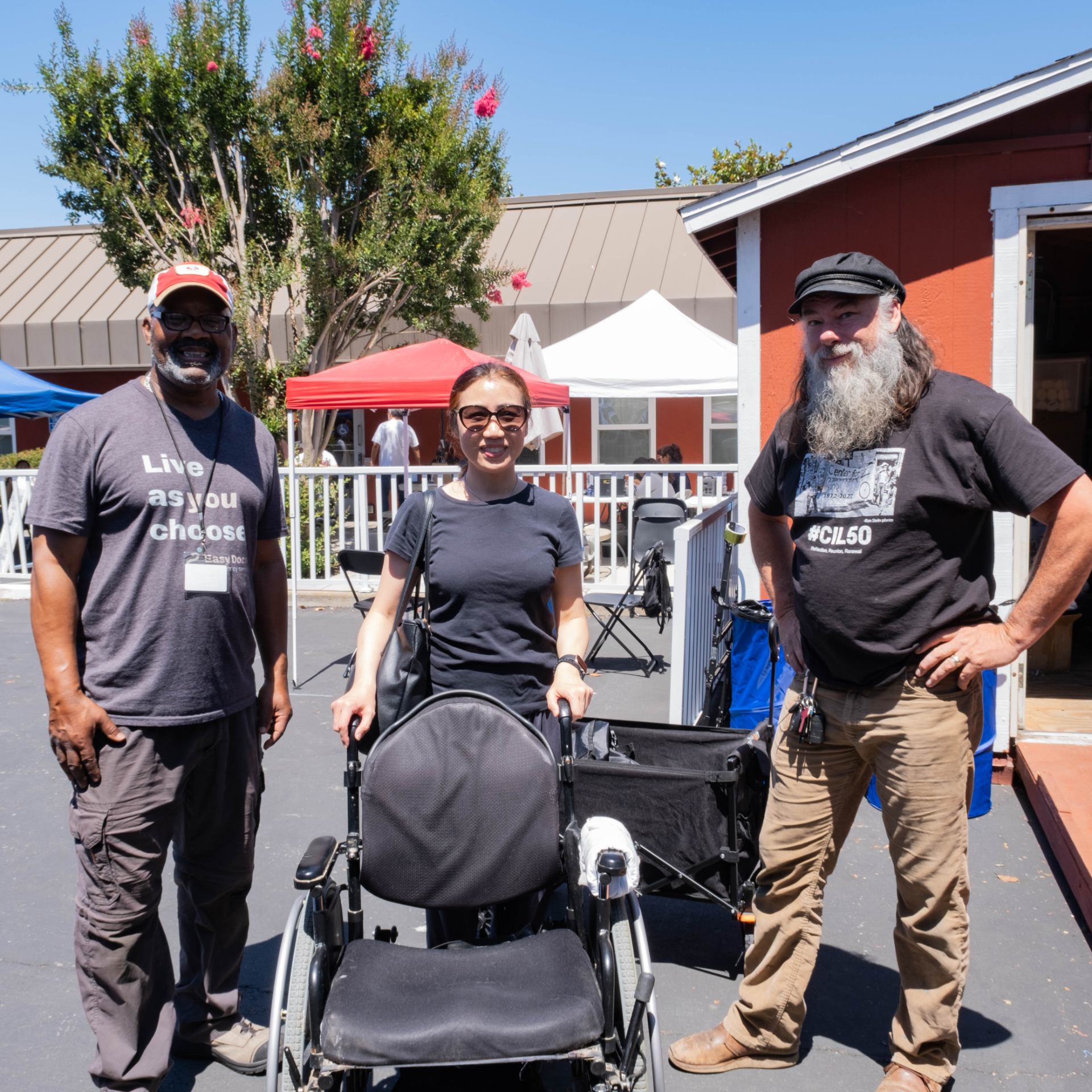 Richard and John pose for a photo with a client whose power chair they just serviced.